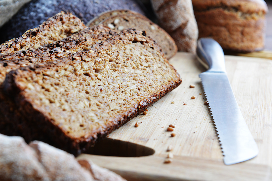 Ezekiel Bread sliced on a wooden cutting board